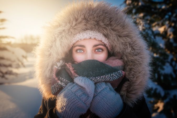 Young woman smiling on snowy background