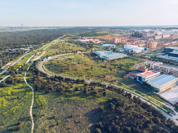 Picturesque distant urban city surrounded with fields and forest