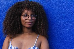 Trendy female against bright wall