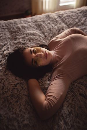 Young woman lying on bed