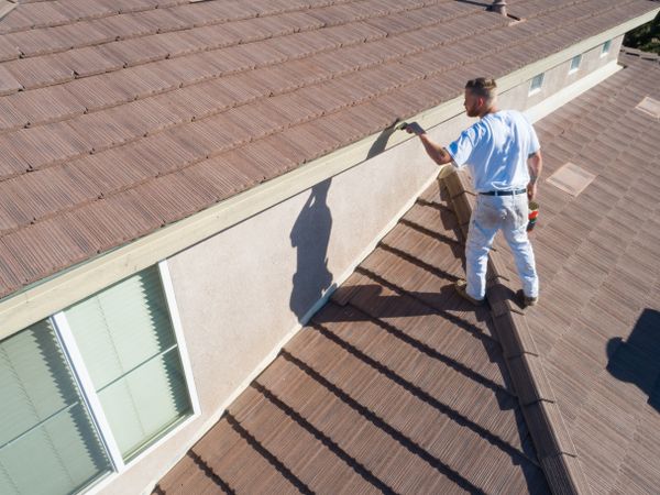 Professional Painter Using A Brush to Paint House Fascia