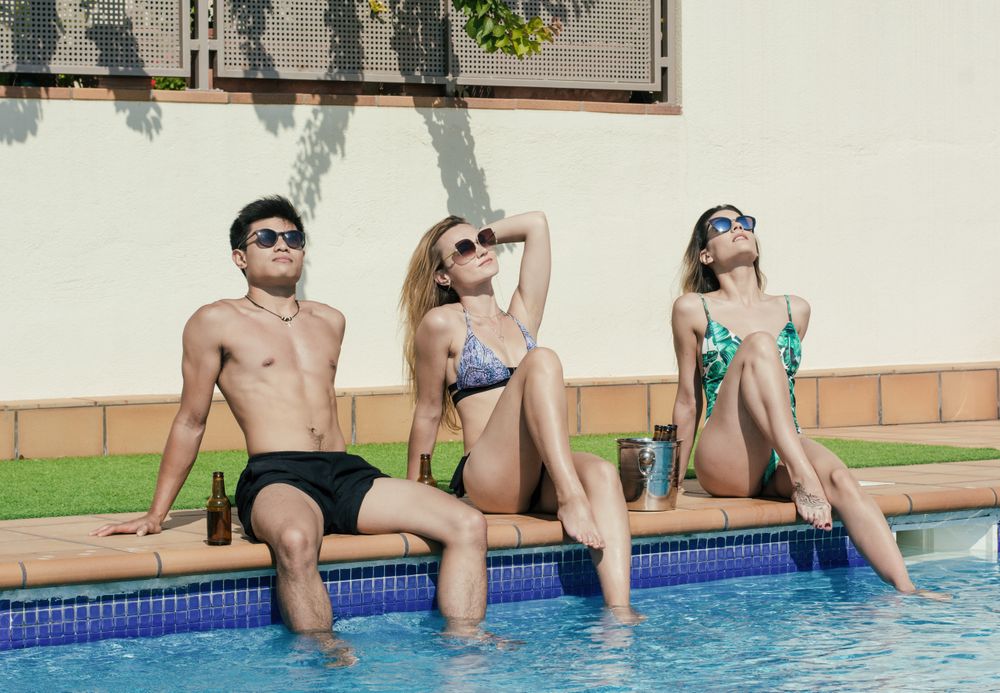 Group of friends sunbathing by the on a summer day