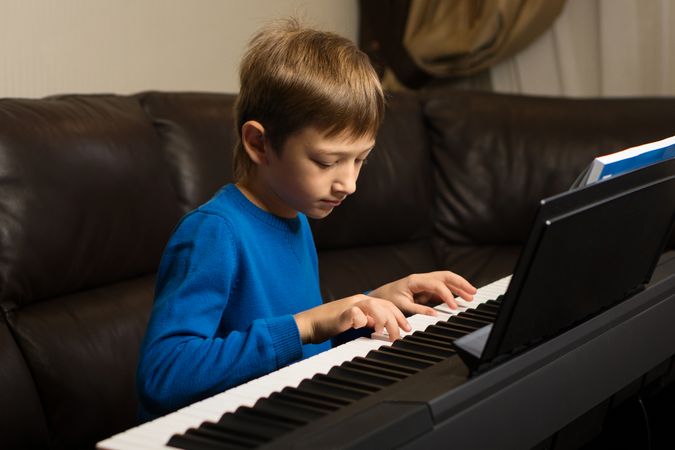 Focused Boy Playing Piano
