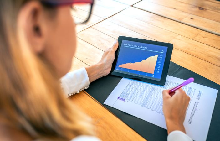 Businesswoman analyzing market evolution with tablet