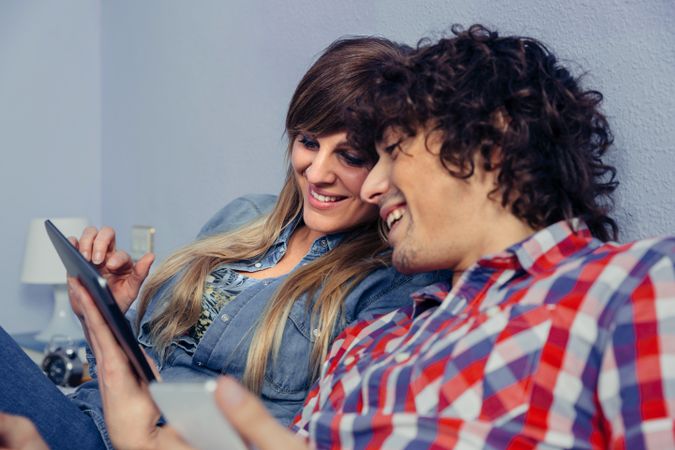 Couple in love looking electronic tablet and laughing
