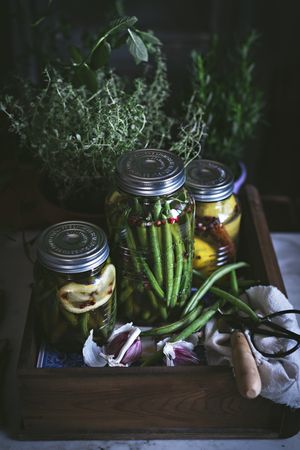 Fresh green vegetables with fruits and glass jars