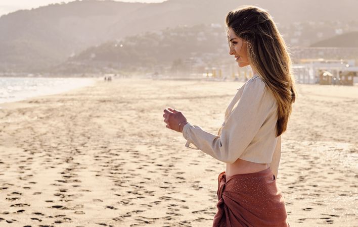 A fashion model at the beach before sunset