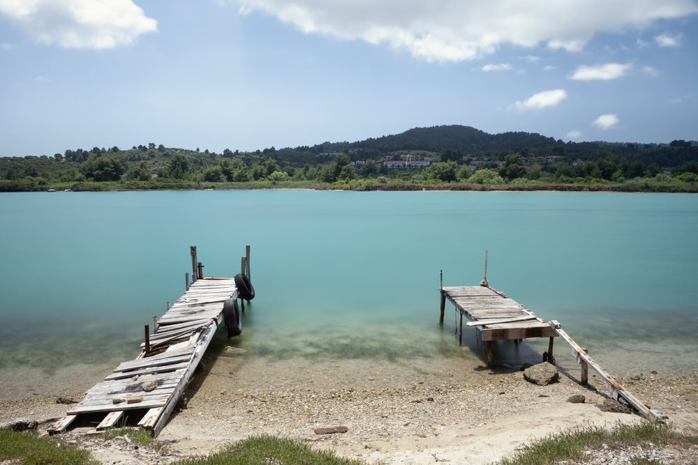 Wooden broken old pier in calm water