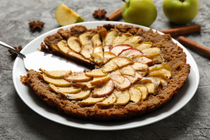 Composition with apple pie and ingredients on gray background. Homemade food