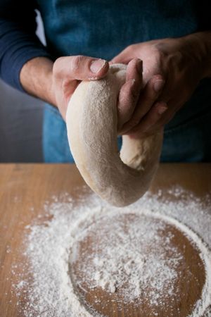 Crop man preparing Rosca de Reyes