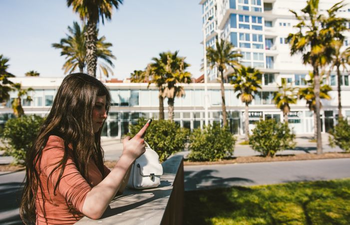 Teen girl looking at her smartphone.