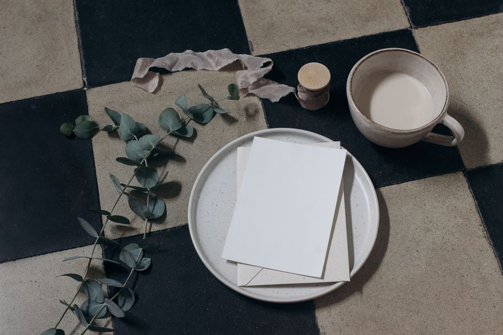Moody blank greeting card, invitation mockup with eucalyptus tree branches and ribbon