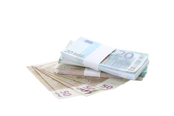 Stacks of American cash money, isolated on light background