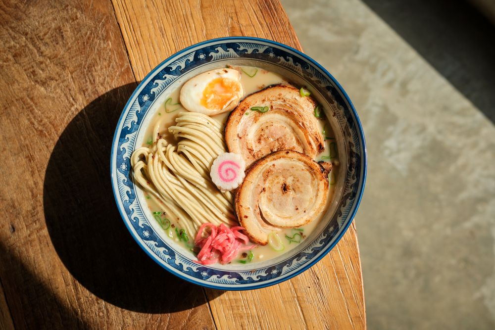 Ramen on Sunlit Wooden Table