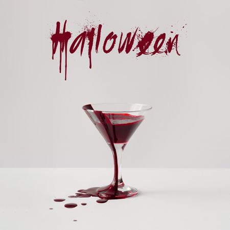 Martini glass full of blood with “Halloween” text
