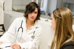 Female doctor with patient in clinic