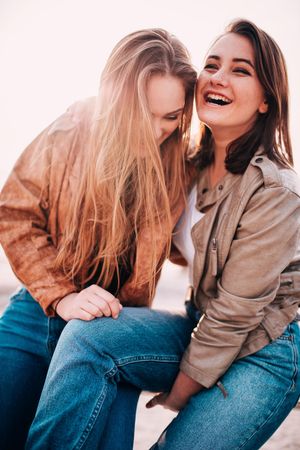 Two young women laughing and smiling with each other