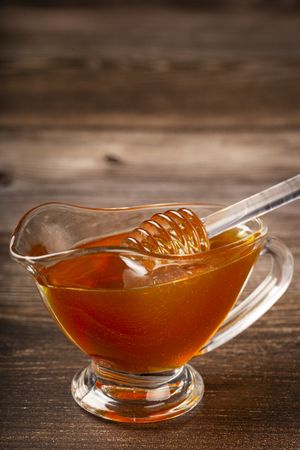 Honey in glass bowl on the table.