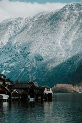 Houses in water on coast near mountains