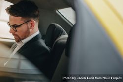 Side view of a businessman sitting in car looking busy bDYY80