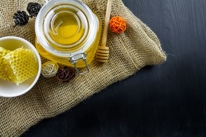 Overhead Honeycomb and Honey Jar on Burlap