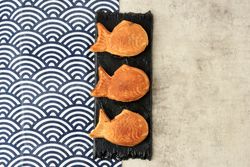 Three Japanese taiyaki waffles on rectangular plate