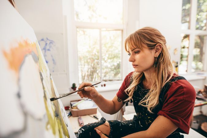 Female artist in her workshop painting