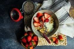 Top view of bowl of oatmeal, chia seeds and strawberry