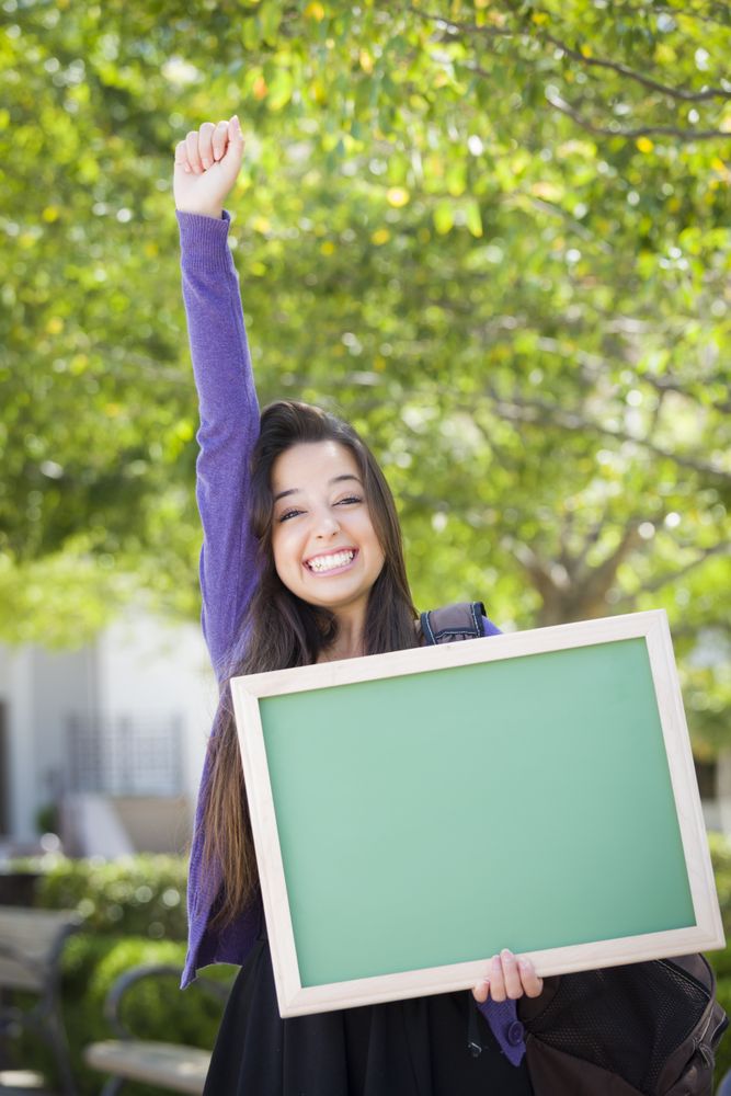Excited Female Student Holding Green Chalkboard