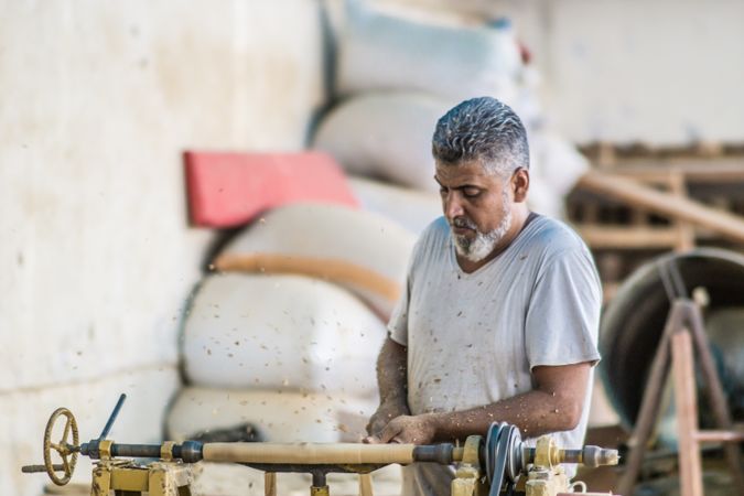 Man using woodworking machine at workplace