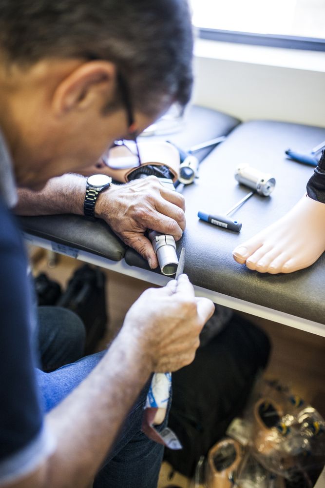 man fixing a prosthesis in a workshop
