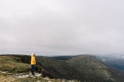 Man standing on top of hill