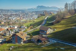Town on green slope of mountains