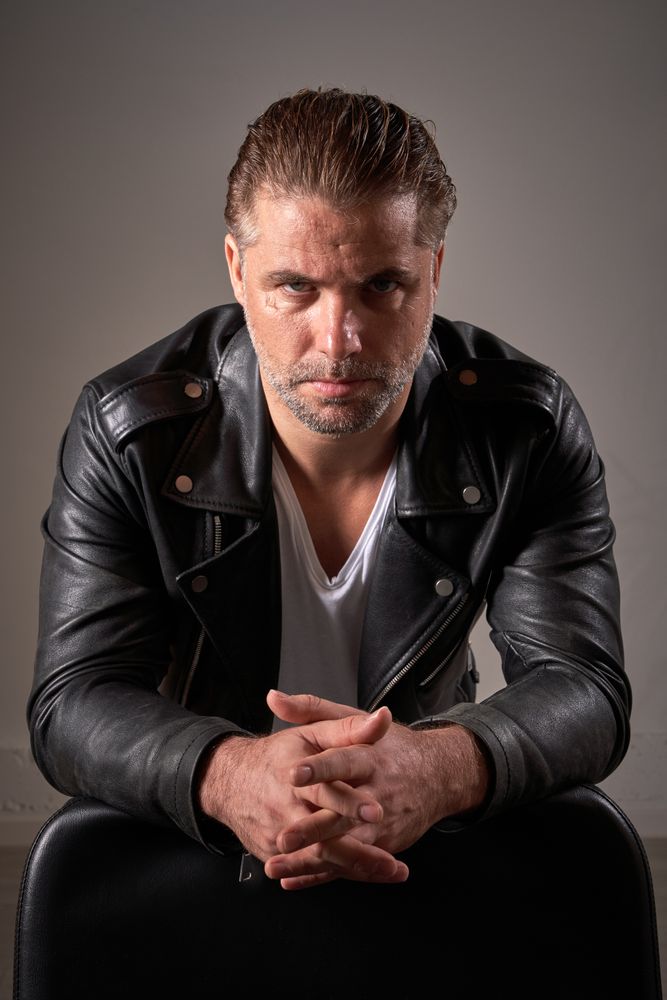Confident man looking at camera in barbershop