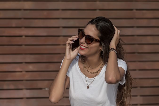 Woman wearing sunglasses talking on the phone