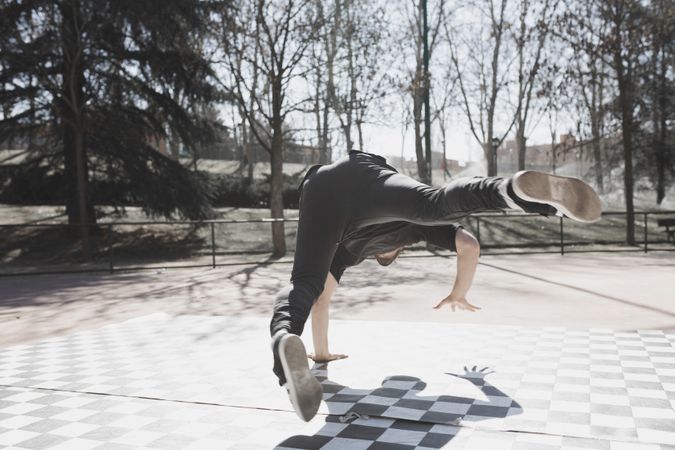 Man dancing break dance in park