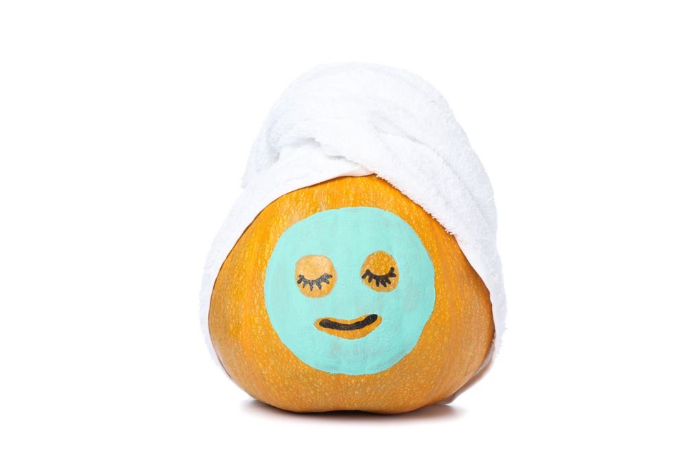Pumpkin with facial mask and towel