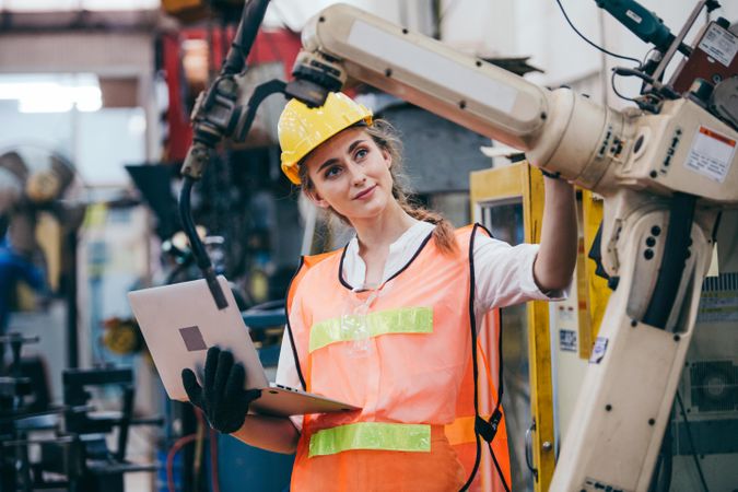 Female industrial engineer or technician worker in hard helmet