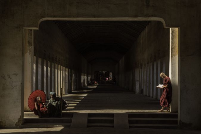 Buddhist monks in hallway in Myanmar during daytime