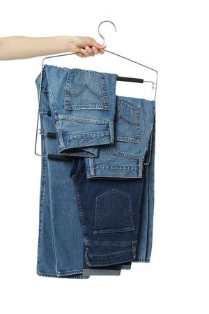 Jeans on hangers, isolated on light background