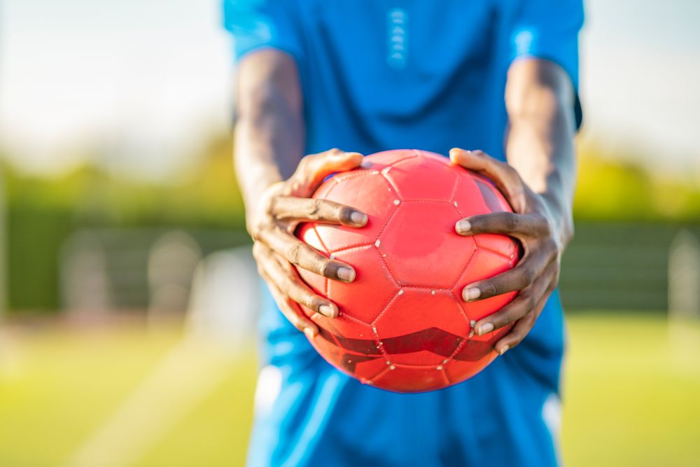 Black football player with ball