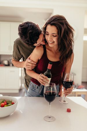 Romantic couple in the kitchen with wine