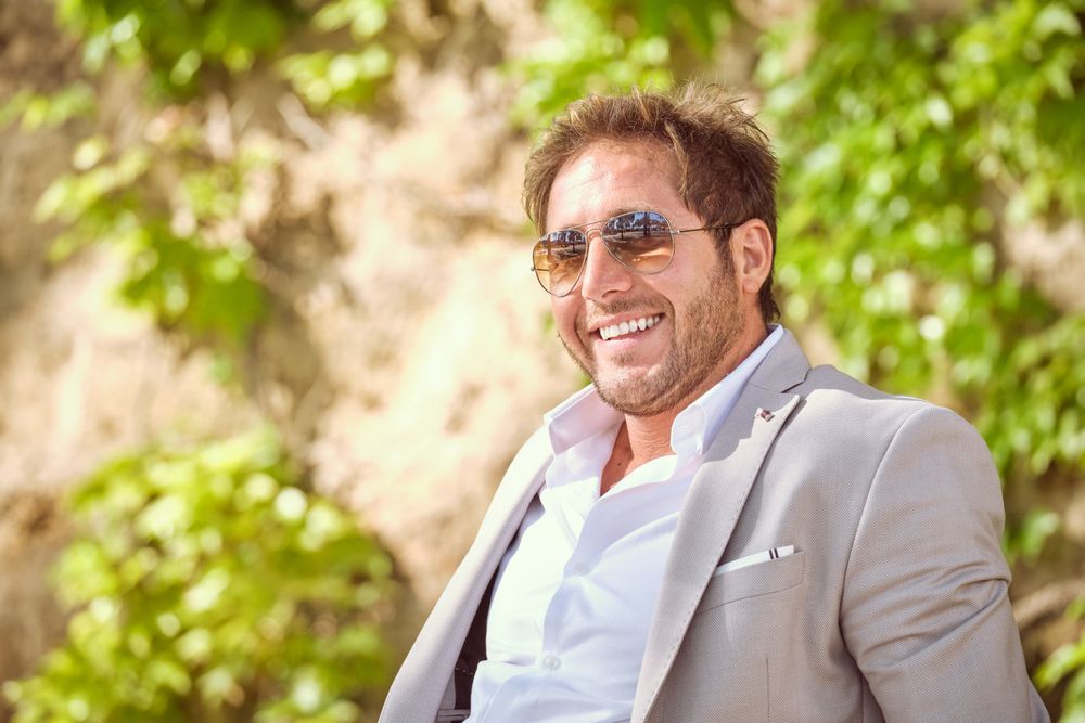 Cheerful man in sunglasses in bright light