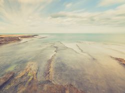 Rocky seashore under blue sky