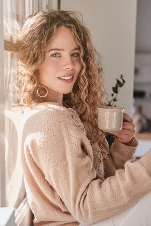 Smiling woman with cup of coffee