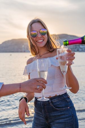 Happy family drinking wine on beach