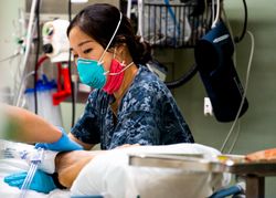 Los Angeles, CA, USA - April 28, 2020: Lt. j.g. adjusts a pillow aboard USNS Mercy