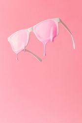Pink paint dripping out of lenses of sunglasses