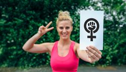 Woman showing symbol of feminism
