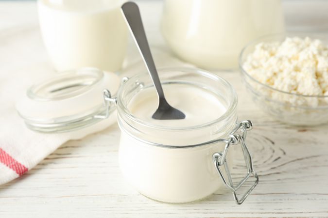 Different dairy products on wooden background, close up